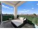 Inviting balcony featuring a comfortable daybed and a verdant privacy screen at 19329 Watermark Dr # 551/552, Cornelius, NC 28031