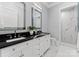 Elegant bathroom with marble floors, black countertops, and dual mirrors at 19329 Watermark Dr # 551/552, Cornelius, NC 28031