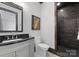 Stylish powder room with a dark accent shower and a framed mirror at 19329 Watermark Dr # 551/552, Cornelius, NC 28031