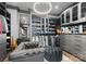 The closet is a large dressing room, featuring recessed lights, mirrored doors, seating, and rods for hanging clothing at 19329 Watermark Dr # 551/552, Cornelius, NC 28031