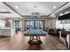 Spacious game room boasts a pool table, modern lighting, and stylish decor for entertainment and relaxation at 19329 Watermark Dr # 551/552, Cornelius, NC 28031