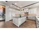 A kitchen with stainless steel appliances, wooden floors and a center island with an elegant countertop and cabinetry at 19329 Watermark Dr # 551/552, Cornelius, NC 28031