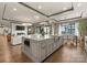 A kitchen with stainless steel appliances, wooden floors, an island with an elegant countertop and an open floor plan at 19329 Watermark Dr # 551/552, Cornelius, NC 28031