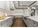 A kitchen with stainless steel appliances, wooden floors, white cabinets, and a stylish backsplash adding character to the space at 19329 Watermark Dr # 551/552, Cornelius, NC 28031