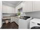 Well-organized laundry room with modern appliances, custom cabinetry, and a built-in desk at 19329 Watermark Dr # 551/552, Cornelius, NC 28031