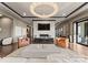 A bright living room features a large marble coffee table, fireplace and a circular chandelier illuminating the open space at 19329 Watermark Dr # 551/552, Cornelius, NC 28031