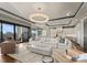 A bright living room features a large white sofa, marble coffee table, and access to an outdoor balcony with scenic views at 19329 Watermark Dr # 551/552, Cornelius, NC 28031