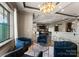 A living room featuring stylish blue furniture, a glass coffee table, and a stunning chandelier illuminating the open space at 19329 Watermark Dr # 551/552, Cornelius, NC 28031