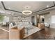 A bright living room features a large white sofa, marble coffee table and connects to the kitchen and dining areas at 19329 Watermark Dr # 551/552, Cornelius, NC 28031