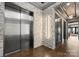 Modern lobby showcases a sleek elevator, stone accent wall, and contemporary lighting with hardwood floors at 19329 Watermark Dr # 551/552, Cornelius, NC 28031
