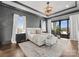 A luxurious main bedroom offers a tray ceiling, outdoor access, and is adorned with neutral-colored walls and finishes at 19329 Watermark Dr # 551/552, Cornelius, NC 28031