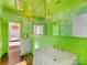 A quirky bathroom design features bold green walls, a floral wallpaper, and elegant fixtures creating a unique and memorable space at 2109 Wellesley Ave, Charlotte, NC 28207