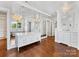 Spacious bathroom with white cabinets, vanity, mirrors, and stylish lighting fixtures at 2109 Wellesley Ave, Charlotte, NC 28207