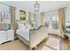 This bedroom features a beautifully upholstered bed, large windows, and stylish decor, creating a comfortable and inviting space at 2109 Wellesley Ave, Charlotte, NC 28207