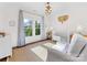 This sunny Bedroom features a crib, soft seating, and cheerful accents, making it a cozy space for your little one at 2109 Wellesley Ave, Charlotte, NC 28207
