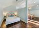 Bright bedroom featuring a comfortable bed, separated from the living area with wood floors at 2109 Wellesley Ave, Charlotte, NC 28207