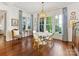 Bright dining room featuring hardwood floors, beautiful chandelier, and natural light from large windows at 2109 Wellesley Ave, Charlotte, NC 28207