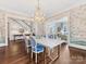 View of dining room with marble table, chandelier, and staircase and living room in background at 2109 Wellesley Ave, Charlotte, NC 28207