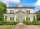 Charming brick home with white pillars, manicured landscaping and covered front porch at 2109 Wellesley Ave, Charlotte, NC 28207
