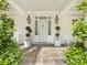 Inviting front porch featuring a blue door, potted plants, and classic white rocking chairs at 2109 Wellesley Ave, Charlotte, NC 28207