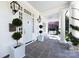 Welcoming front porch with slate flooring, rocking chairs, and a swing at 2109 Wellesley Ave, Charlotte, NC 28207