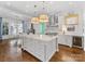 Spacious kitchen with a large island, stainless steel appliances, and wine fridge, open to dining at 2109 Wellesley Ave, Charlotte, NC 28207