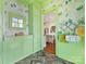 Charming mud room featuring brick floors, colorful wallpaper, and view to the kitchen at 2109 Wellesley Ave, Charlotte, NC 28207