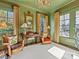 Cozy office space with green walls, a chandelier and a swing in the window view at 2109 Wellesley Ave, Charlotte, NC 28207