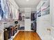 This walk-in closet offers ample storage with custom shelving and organization solutions, including drawers and racks at 2109 Wellesley Ave, Charlotte, NC 28207