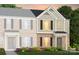 New two-story townhouse with brick and siding, black shutters, and colorful landscaping at 2230 Cobble Ct # 154, Monroe, NC 28110