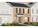 Charming two-story townhome showcasing a brick facade, black shutters, and inviting front door at 2232 Cobble Ct # 153, Monroe, NC 28110