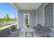 Cozy covered porch with stylish seating and a view of the neighborhood at 2236 Cobble Ct # 151, Monroe, NC 28110