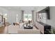 Sunlit living room showcases a chic sectional sofa, modern furnishings, and large windows at 2236 Cobble Ct # 151, Monroe, NC 28110