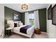 Comfortable bedroom with an accent wall, modern décor, and a window overlooking the street at 2241 Cobble Ct # 221, Monroe, NC 28110