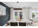 Dining area featuring a modern table, stylish chairs, and views of the fenced backyard through the doors and windows at 2241 Cobble Ct # 221, Monroe, NC 28110