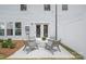 Private patio with modern outdoor seating surrounded by a fenced yard and well-maintained landscaping at 2241 Cobble Ct # 221, Monroe, NC 28110