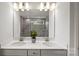 Elegant bathroom featuring a double vanity, stone backsplash, and a glass-enclosed shower at 2243 Cobble Ct # 222, Monroe, NC 28110