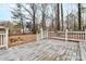 Fenced backyard with fire pit viewed from weathered deck at 2321 Heathershire Ln, Matthews, NC 28105