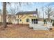 Backyard with a yellow house, a deck, and many trees at 2321 Heathershire Ln, Matthews, NC 28105