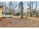 Leaf-covered backyard showing the deck, fire pit and privacy fence at 2321 Heathershire Ln, Matthews, NC 28105