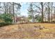 Large backyard featuring a fire pit and a classic wooden fence at 2321 Heathershire Ln, Matthews, NC 28105