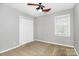 Bright bedroom with a ceiling fan, window with blinds, closet, and neutral colored carpet at 2321 Heathershire Ln, Matthews, NC 28105