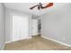 Comfortable bedroom featuring neutral carpet, ceiling fan, and closet space at 2321 Heathershire Ln, Matthews, NC 28105