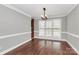 Dining room featuring hardwood floors, natural light, and elegant trim at 2321 Heathershire Ln, Matthews, NC 28105