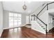 Bright foyer with hardwood floors, showcasing the staircase and front entrance at 2321 Heathershire Ln, Matthews, NC 28105