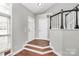Welcoming foyer with hardwood floors, staircase, and a view of the front door at 2321 Heathershire Ln, Matthews, NC 28105