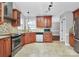 Updated kitchen boasts stainless steel appliances, tile backsplash, granite counters, and ample cabinet space at 2321 Heathershire Ln, Matthews, NC 28105
