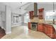 Open-concept kitchen with stainless steel appliances, tile flooring, and a modern range hood at 2321 Heathershire Ln, Matthews, NC 28105