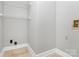 Clean and functional laundry room with tile flooring and wire shelving at 2321 Heathershire Ln, Matthews, NC 28105