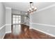 Spacious living room with hardwood floors, ample natural light, and elegant trim at 2321 Heathershire Ln, Matthews, NC 28105